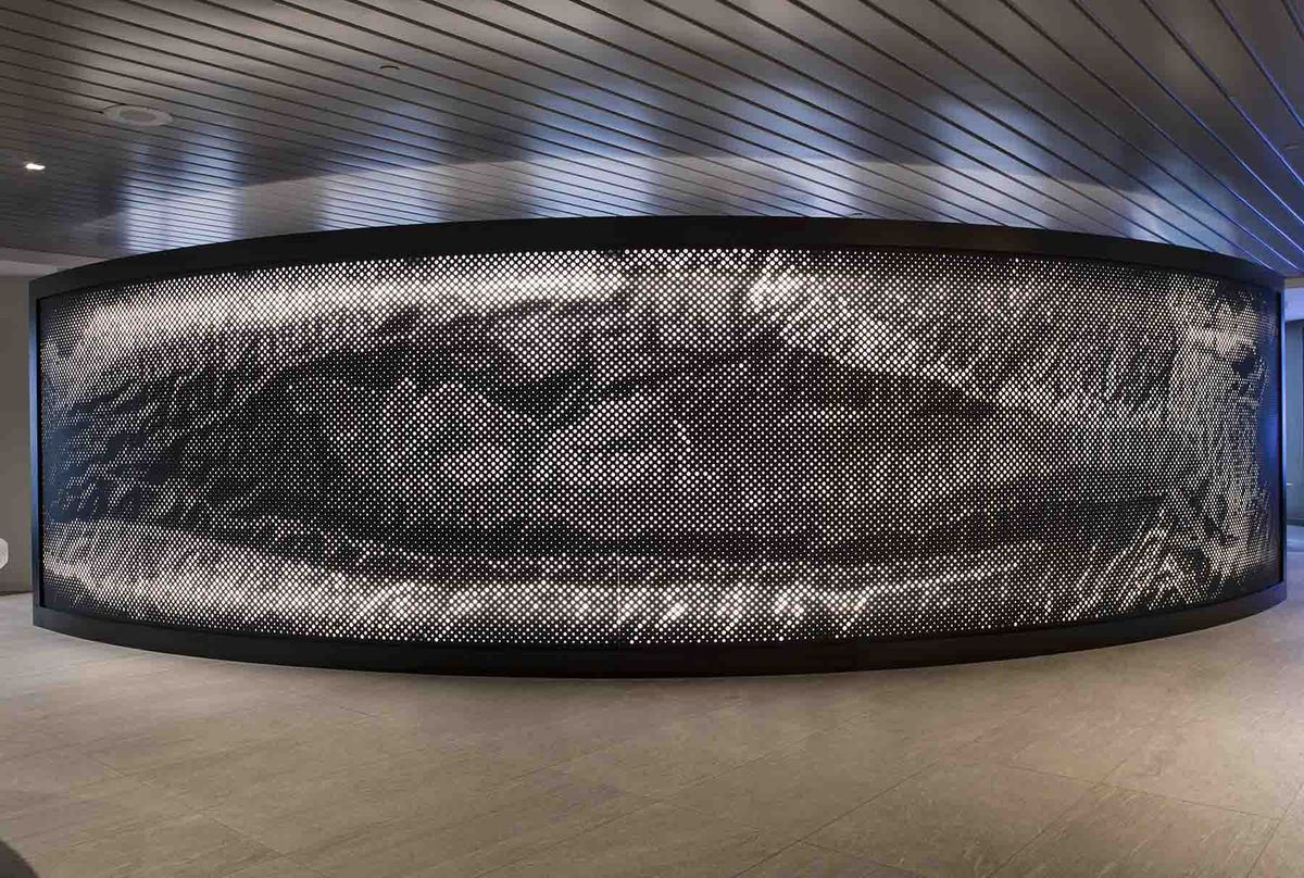 Backlit aluminum wall panel as dramatic architectural feature