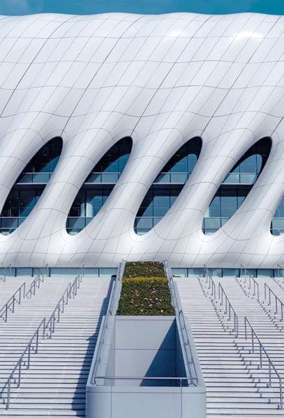 Curved metal panels for architectural facade